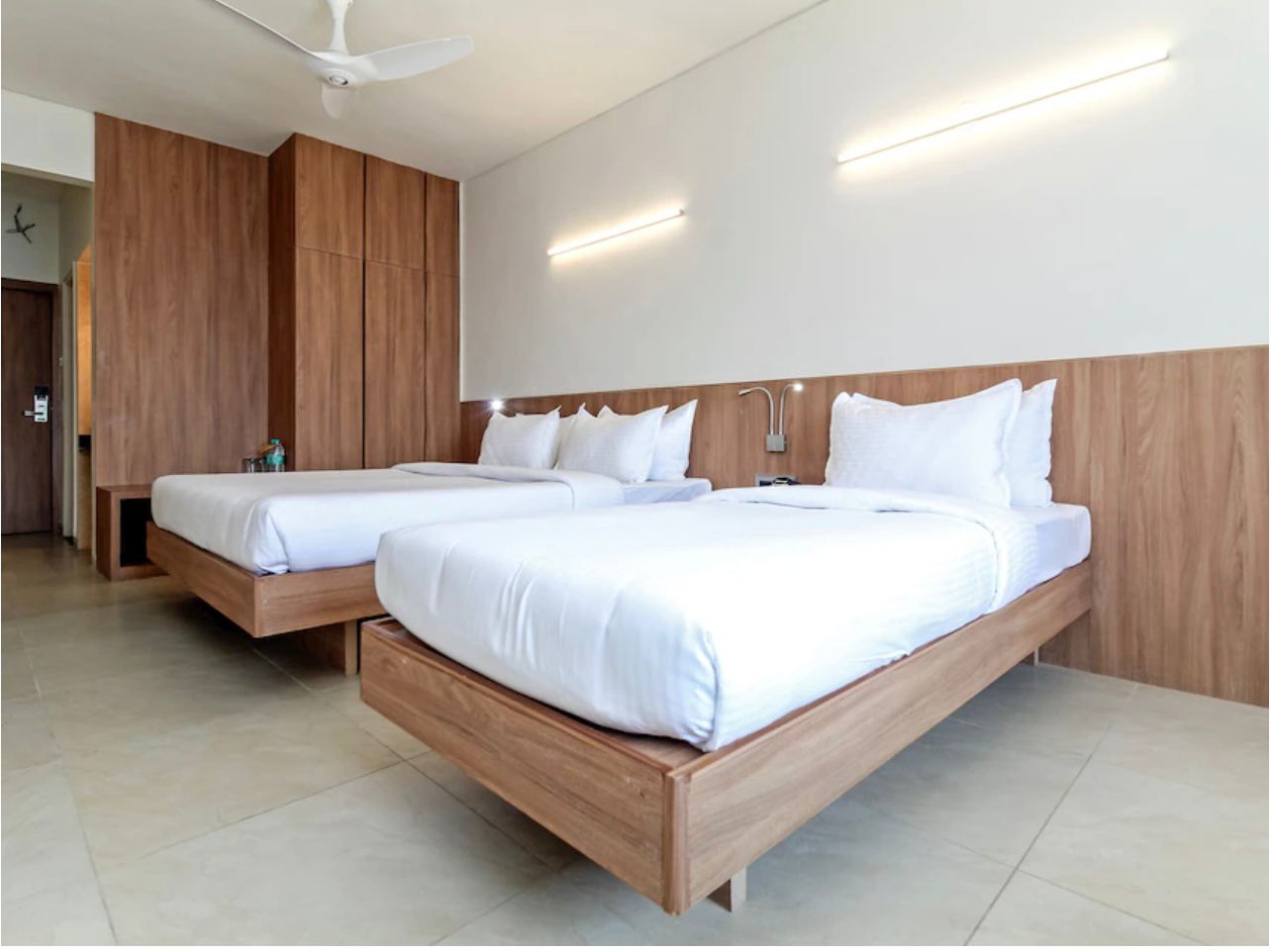 AC Triple Deluxe Room featuring one king and one single bed, ideal for three guests staying in central Nashik